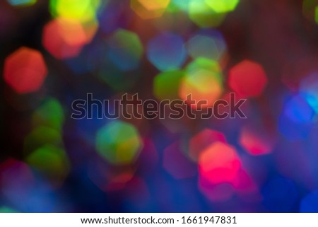 Vibrant holographic glowing rainbow colors neon bokeh background. Seasonal light decorative abstract design element.