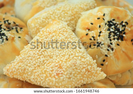 A picture of a Chinese pastry With white sesame seeds and black sesame seeds sprinkled on top