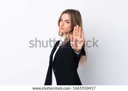 Young business woman over isolated white background making stop gesture with her hand