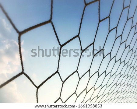 soccer net with a blue sky in the background