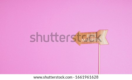 Photo prop for wedding or married sign on pink background.