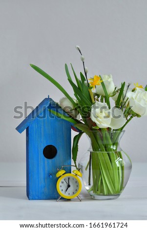 bouquet of spring flowers and a bright blue birdhouse on a pink background. picture for packages.Spring mood. Spring card for Mother's Day, Women's Day. Template greeting card .copy space.