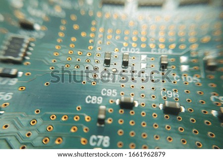 Closeup green computer PCB board. Macro picture of green printed circuit board - PCB.