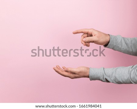 Men's hands on a pink background, design blank with empty space.