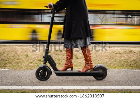 Person on an electronic scooter in the city Royalty-Free Stock Photo #1662013507