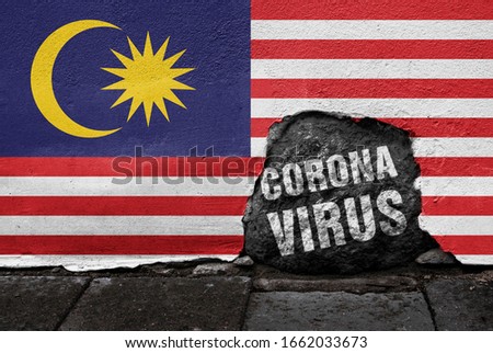 Flag of Malaysia on the wall with cracked stone with Coronavirus name on it. 2019 - 2020 Novel Coronavirus (2019-nCoV) concept, for an outbreak occurs in Malaysia.
