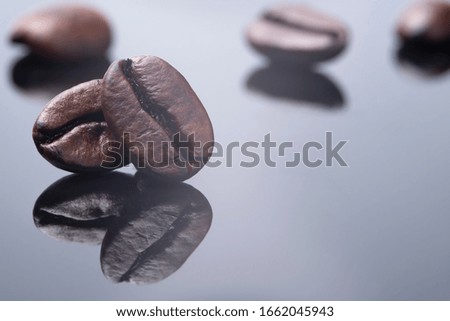 cutout picture pair harmony coffee bean roast with dark brown colour textured isolated on shiny black and white backgrounds with shadow reflexing, quality huge grained beverage coffee energy drink