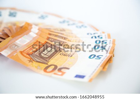50, 20, 10 and 5 euro bills on a white background. Photographed with sharpness and blur. Money from the German Euro area. 