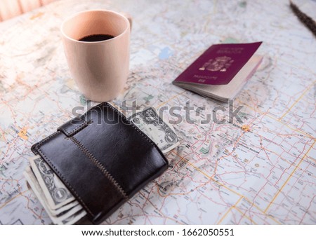 
a map a passport a cup of coffee a wallet with money