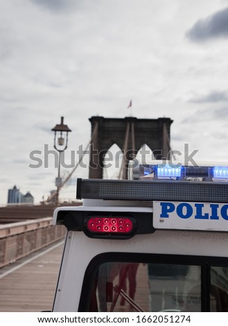 Close up of a NYPD  New York police vehicle on the Brooklyn bridge with blurred background.