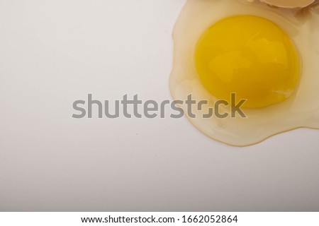 Broken chicken egg on a white background. Close up.