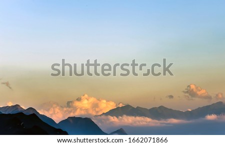 Green mountain range sky scene white clouds panorama.