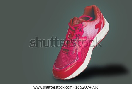 Healthy red sports shoes that are isolated from the gray background that cuts