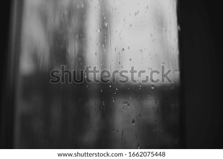 Window in the raindrops. Black and white photo.