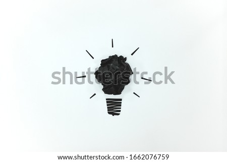 Black light bulb isolated in white background flat lay. Lack of creativity, drained and blank mind concept.