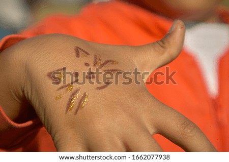 Hand of a child with drawing with joy smiling face