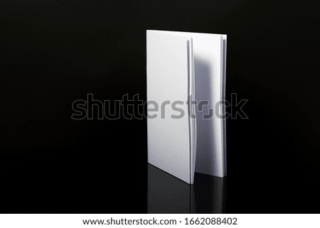 Photo of Blank Magazine Or Brochure or book Cover Isolated On Black background.