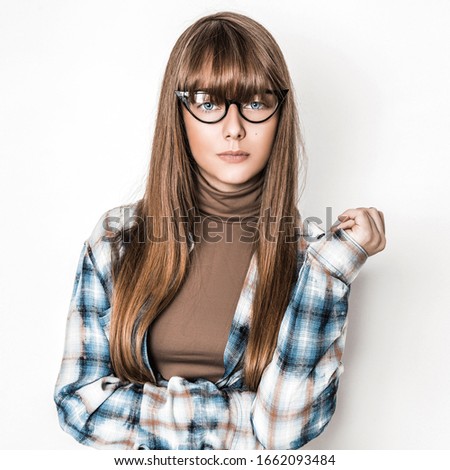 Beauty young girl with long smooth hair and  glasses on white background. Young model with eyeglasses and trendy bangs