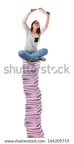 young woman reading a book on a books tower