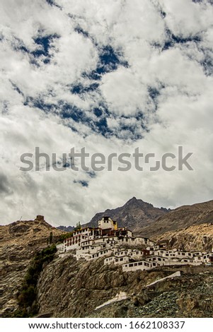 A bottom up wide angle picture of the full Diskit Monastery in Nubra valley, Leh-Ladakh. The Texture in the clouds and mountains adds to the mood of the image.