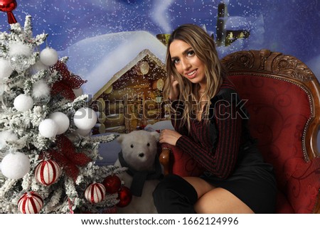 Holidays. Beautiful blonde girl posing in studio. Winter, Christmas, celebration concept. 