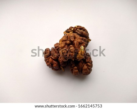several peeled round walnuts on a white background closeup photo