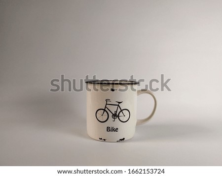 White ceramic cup with attractive bicycle pictures and white background