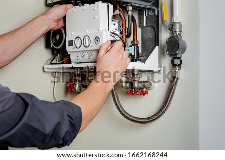 Repair of a gas boiler. Royalty-Free Stock Photo #1662168244