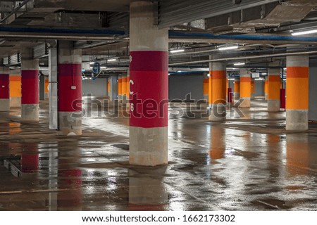 Empty underground parking lot for concept design. Modern city transport parking with neon illumination.