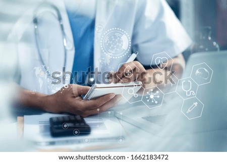 Double exposure of healthcare And Medicine concept. Doctor holding book and working on desk at the hospital and modern virtual screen interface.