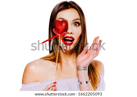 Beautiful Young woman model holding a red heart decoration