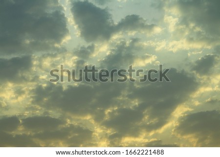 Texture of soft grey cloudy on soft shade blue sky with yellow light sunshine morning