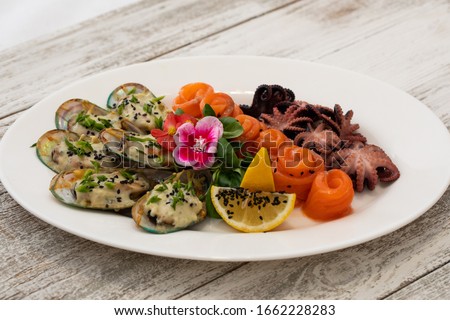 Seafood plate with lemon and sesame seeds
