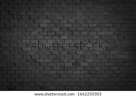 Old brick black color wall. Vintage background Royalty-Free Stock Photo #1662250303