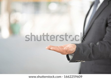 Midsection Of Businessman Gesturing In Office