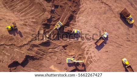 Earthmoving equipment. Aerial view of large construction site with several earthmover machines. Royalty-Free Stock Photo #1662267427