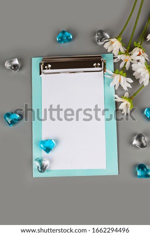 Tablet and hearts on a gray background. Place for your text.