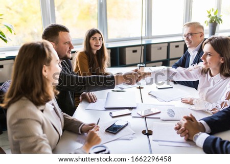 Business people shaking hands, finishing up a meeting Royalty-Free Stock Photo #1662296458