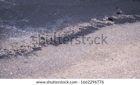 Asphalt filled with oil stains Background textured driveway top view                       