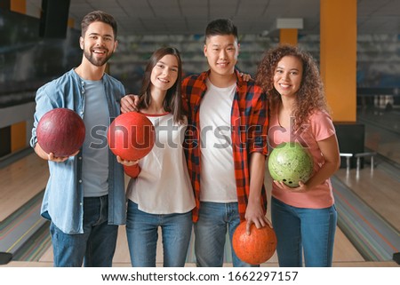 Happy friends in bowling club