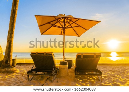Beautiful tropical nature umbrella chair with palm tree around beach sea ocean at sunset or sunrise for travel vacation