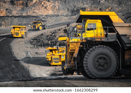 Open pit mine industry, big yellow mining truck for coal anthracite. Royalty-Free Stock Photo #1662308299