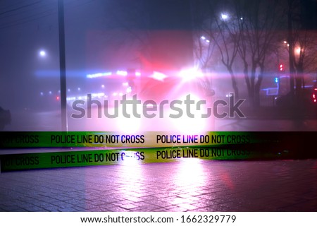 police line do not cross ribbon in front of the police car in the night
 Royalty-Free Stock Photo #1662329779