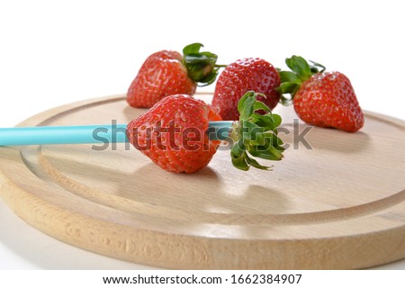 Life hack; Insert the straw into the side opposite to the stem and press it up through the center of the strawberry.    