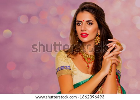 Beauty Portrait indian girl.  Jewelry. Young Hindu woman model with kundan jewelry set. Red lips. Close up. Traditional India  costume  lehenga choli or sari. make-up                               