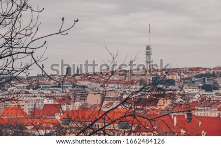 Beautoful Moody Photo of Prague panorama, taken from Letná, with medieval church, famous Zizkova tower and red roofs taken on the winter February afternoon