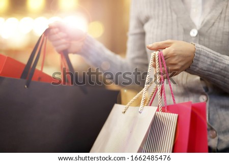 Close up of woman carrying shopping bags Royalty-Free Stock Photo #1662485476