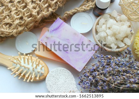 Bathroom accessories.Flat lay photo . Spa-still life of skin care items.Spa accessories-sponge, natural soap, essential oil, pumice, salt, washcloth, comb, candles on a light background, top view. 