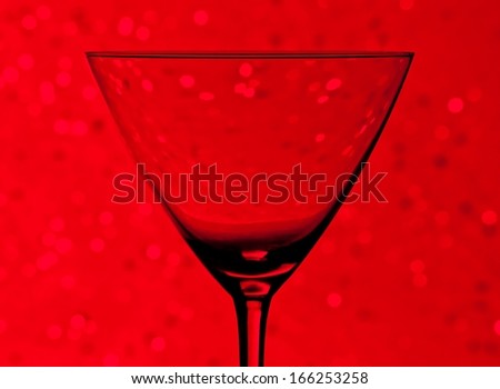 silhouette of empty cocktail glass  on red light tint bokeh background