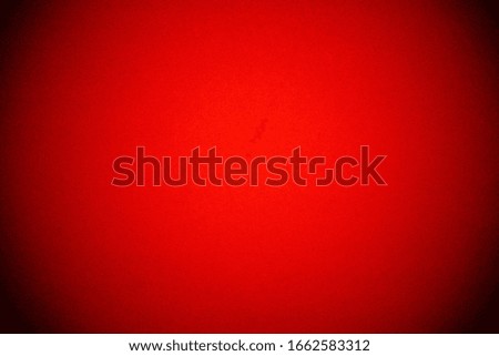 Bright red background with vignetting. The texture of the cardboard